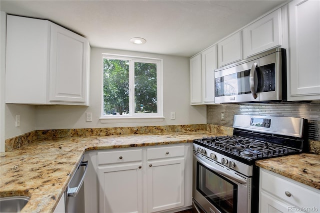 5163 E 123rd Ct, Thornton, CO 80241 - kitchen with stainless steel appliances, white cabinetry, backsplash, and light stone counters