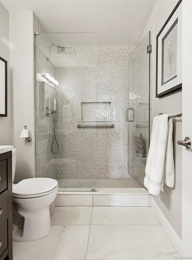 bathroom with vanity, toilet, and an enclosed shower