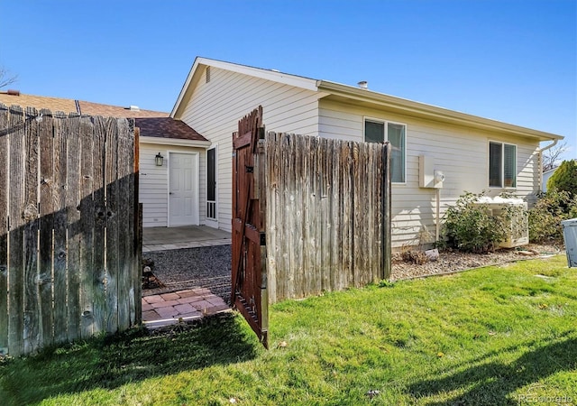 view of side of home featuring a lawn