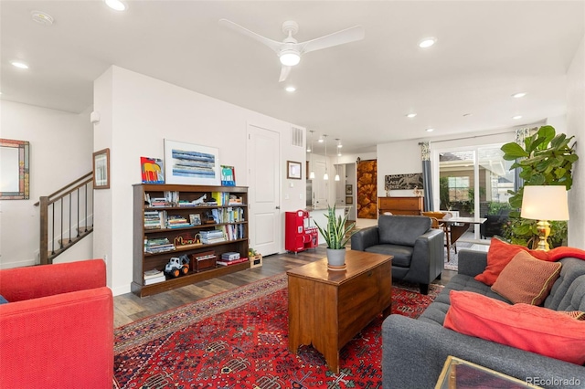 living room featuring dark hardwood / wood-style floors and ceiling fan