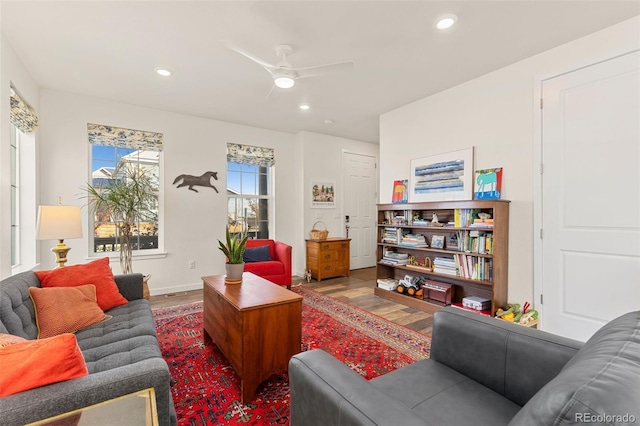 living room featuring ceiling fan and hardwood / wood-style floors