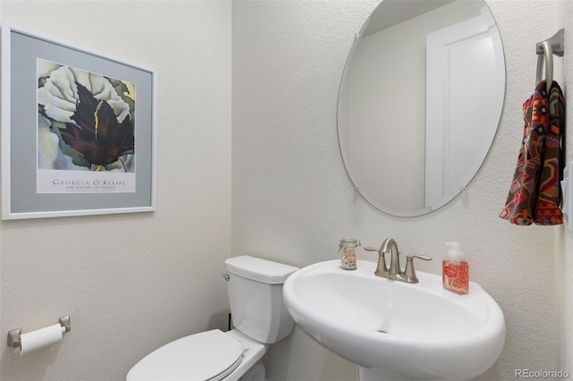 bathroom with toilet and sink