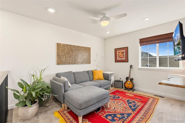 living room with carpet flooring and ceiling fan