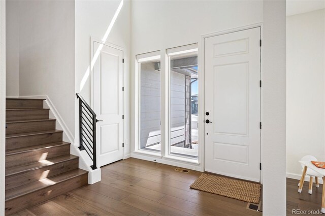 14391 Shasta Daisy Pt, Parker, CO 80134 - foyer entrance with dark wood-style flooring, plenty of natural light, and stairs