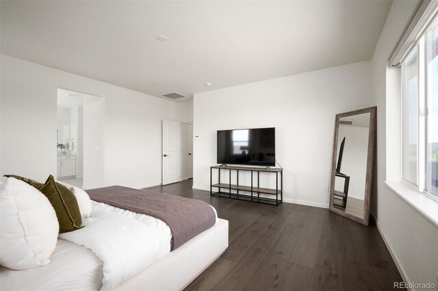 14391 Shasta Daisy Pt, Parker, CO 80134 - bedroom featuring dark wood finished floors, baseboards, and ensuite bathroom