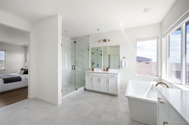 14391 Shasta Daisy Pt, Parker, CO 80134 - full bath featuring healthy amount of natural light, vanity, a marble finish shower, and connected bathroom