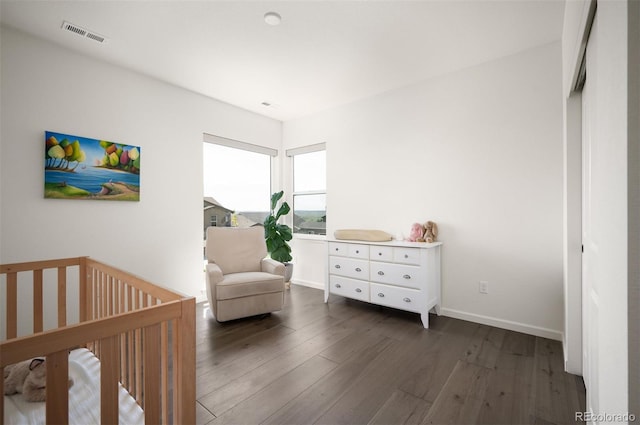 14391 Shasta Daisy Pt, Parker, CO 80134 - bedroom featuring wood finished floors, a nursery area, and baseboards