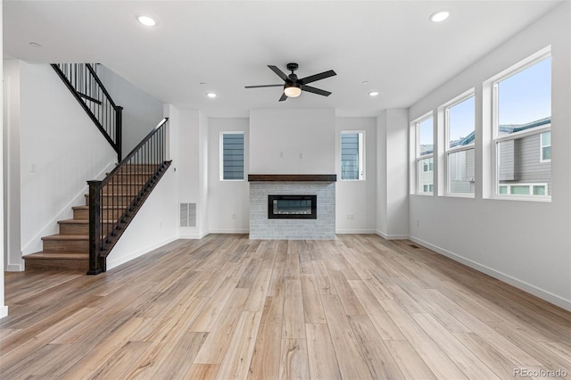 unfurnished living room with ceiling fan and light wood-type flooring