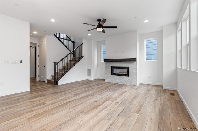 unfurnished living room with light hardwood / wood-style floors and ceiling fan