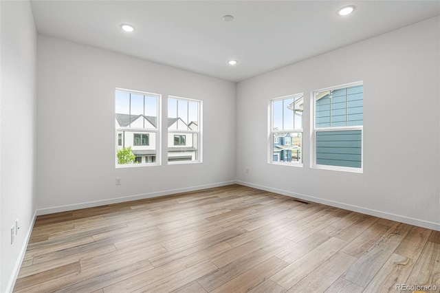 empty room with a healthy amount of sunlight and light wood-type flooring