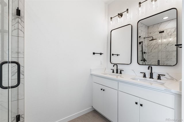 bathroom featuring an enclosed shower and dual bowl vanity