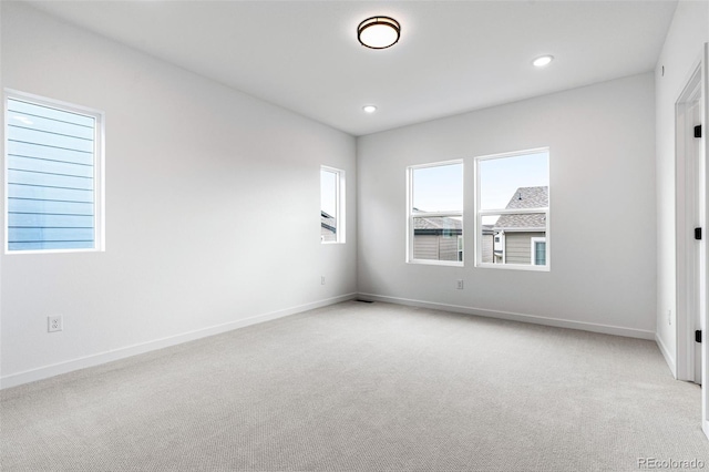 unfurnished room with light carpet