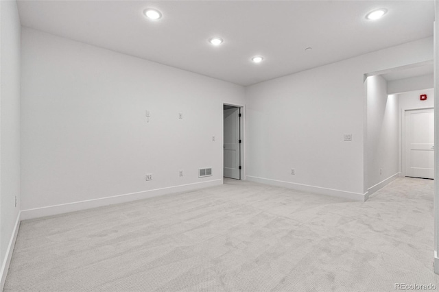 unfurnished room featuring light carpet