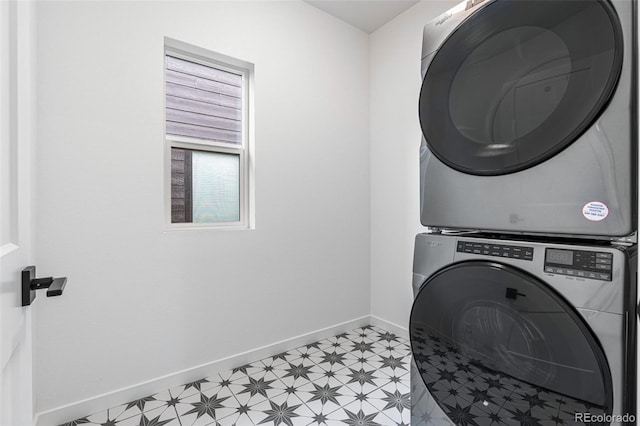 washroom with light tile patterned floors and stacked washer / dryer