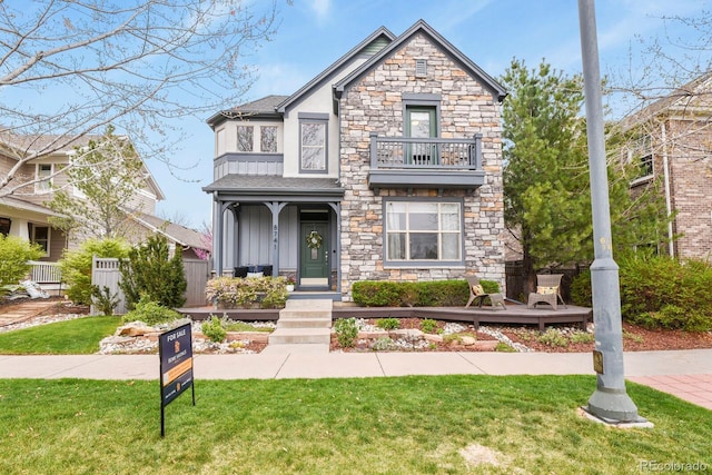 8741 E 29th Ave, Denver, CO 80238 - craftsman house featuring stone siding, stucco siding, a front lawn, and a balcony