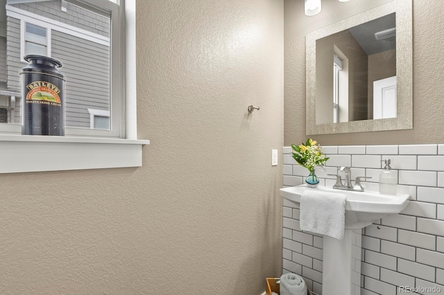 8741 E 29th Ave, Denver, CO 80238 - bathroom featuring tasteful backsplash and a textured wall