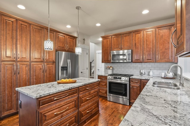 8741 E 29th Ave, Denver, CO 80238 - kitchen featuring pendant lighting, light stone counters, a sink, decorative backsplash, and stainless steel appliances