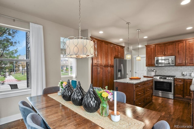 8741 E 29th Ave, Denver, CO 80238 - kitchen with a center island, stainless steel appliances, dark wood finished floors, tasteful backsplash, and recessed lighting