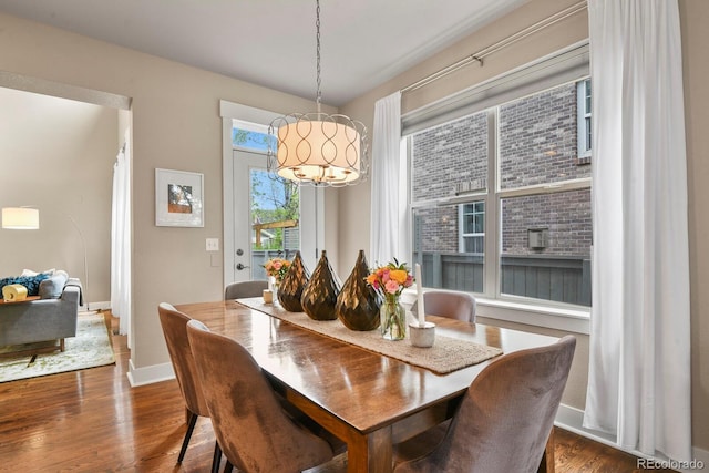 8741 E 29th Ave, Denver, CO 80238 - dining space featuring dark wood-style floors, a notable chandelier, and baseboards