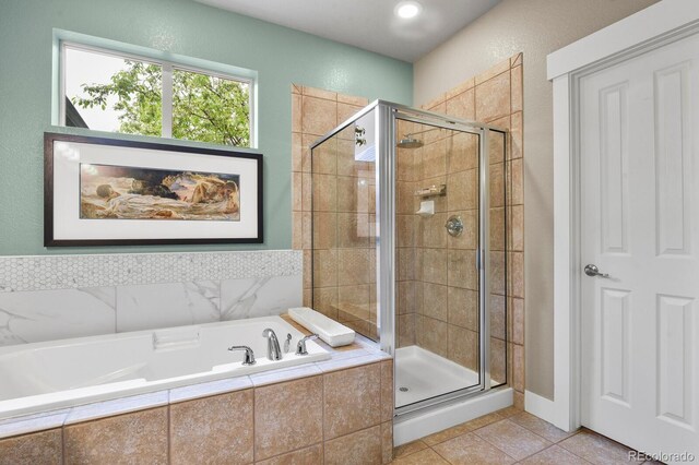 8741 E 29th Ave, Denver, CO 80238 - full bath with a stall shower, tile patterned flooring, and a bath
