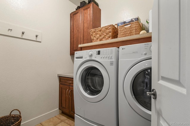8741 E 29th Ave, Denver, CO 80238 - laundry room featuring cabinet space, washing machine and clothes dryer, light tile patterned floors, and baseboards