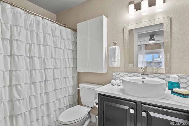 8741 E 29th Ave, Denver, CO 80238 - bathroom with a shower with curtain, toilet, ceiling fan, vanity, and a textured wall
