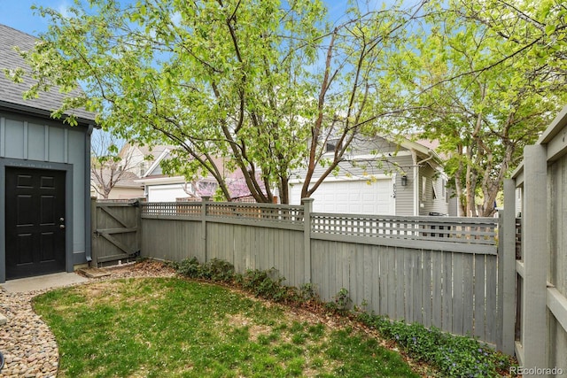 8741 E 29th Ave, Denver, CO 80238 - view of yard featuring a gate, fence, and a garage