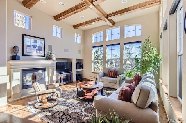 living room with light hardwood / wood-style floors and beam ceiling