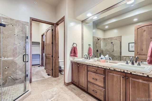 bathroom featuring walk in shower, vanity, and toilet