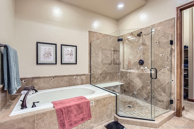 bathroom with tile patterned floors and independent shower and bath