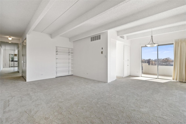 empty room featuring light carpet, a textured ceiling, and beamed ceiling