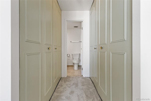 hallway with light colored carpet