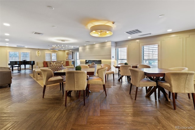 dining space featuring parquet flooring