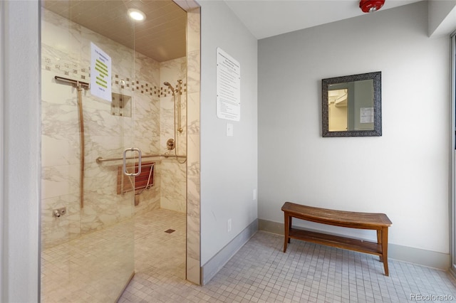 bathroom with an enclosed shower and tile patterned flooring