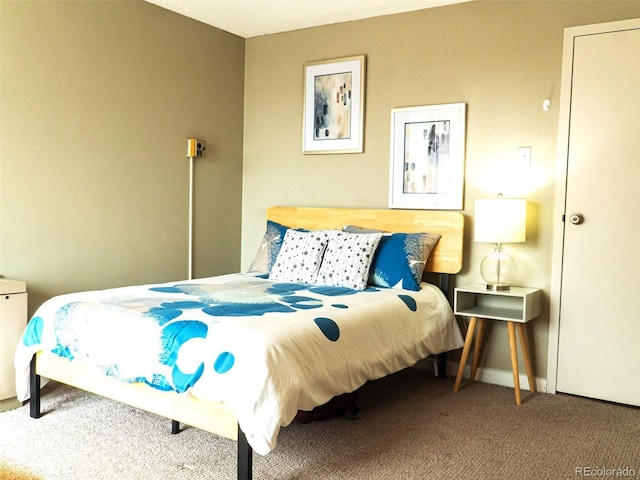 bedroom featuring carpet and baseboards