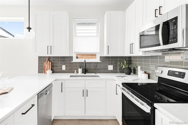 3955 W 13th Ave, Denver, CO 80204 - kitchen featuring stainless steel appliances, white cabinets, and decorative backsplash