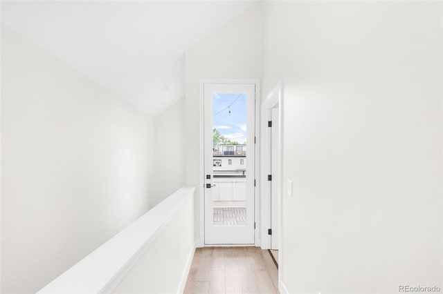 3955 W 13th Ave, Denver, CO 80204 - hall featuring vaulted ceiling, light wood finished floors, and an upstairs landing