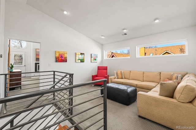 carpeted living area featuring visible vents, recessed lighting, and high vaulted ceiling