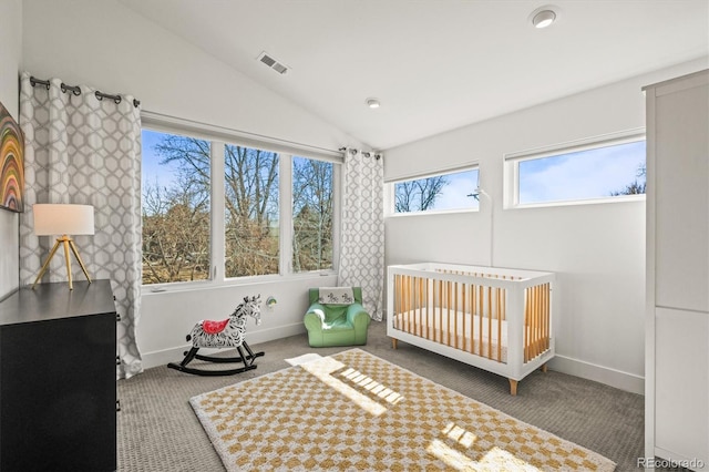 bedroom with visible vents, carpet floors, baseboards, and vaulted ceiling