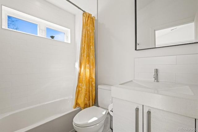 bathroom featuring vanity, toilet, shower / bath combo, and tasteful backsplash