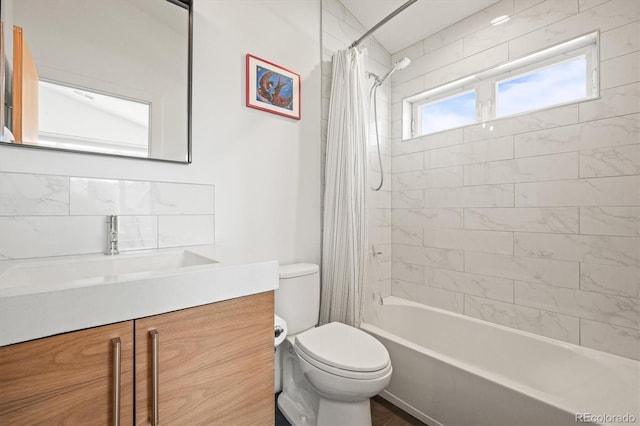 bathroom featuring vanity, toilet, and shower / bath combo with shower curtain