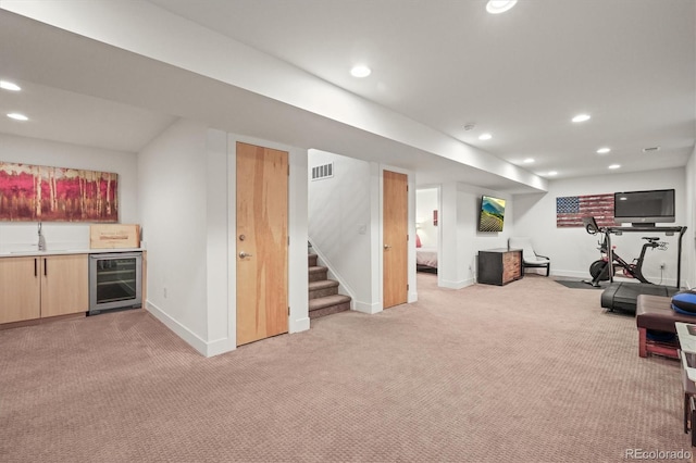 workout area with recessed lighting, wet bar, light carpet, and beverage cooler