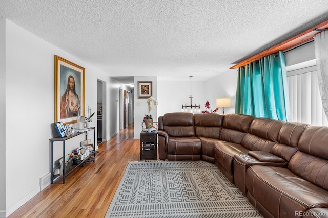 1261 Eagle St, Aurora, CO 80011 - living room featuring light wood-style floors and a textured ceiling