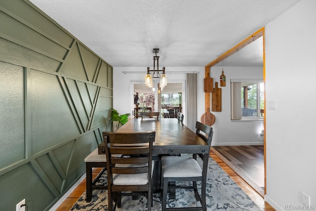 1261 Eagle St, Aurora, CO 80011 - dining space featuring wood finished floors and a textured ceiling