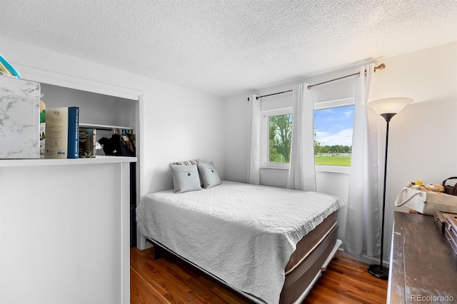 1261 Eagle St, Aurora, CO 80011 - bedroom with wood finished floors and a textured ceiling