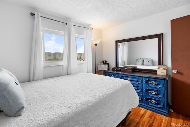 1261 Eagle St, Aurora, CO 80011 - bedroom with a textured ceiling and wood finished floors