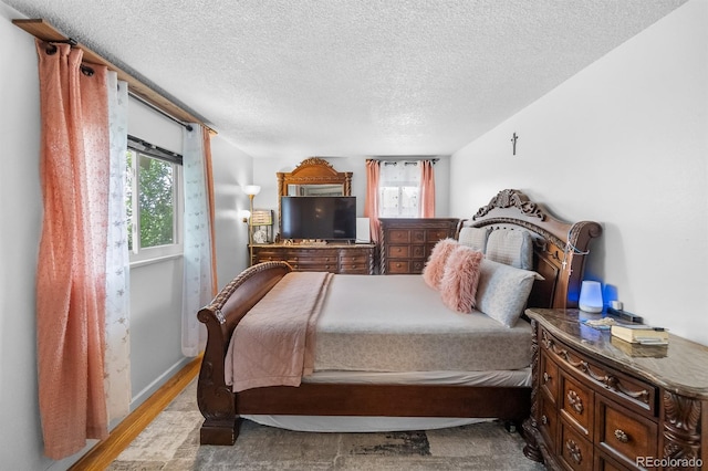 1261 Eagle St, Aurora, CO 80011 - bedroom with wood finished floors and a textured ceiling