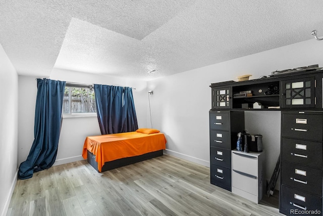 1261 Eagle St, Aurora, CO 80011 - bedroom with a textured ceiling and light wood finished floors