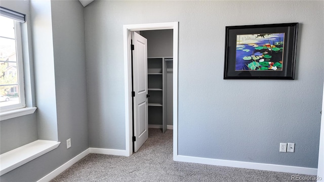 unfurnished bedroom with light carpet and multiple windows