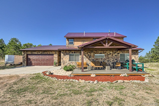 view of front of home featuring a front lawn, a wooden deck, and a garage